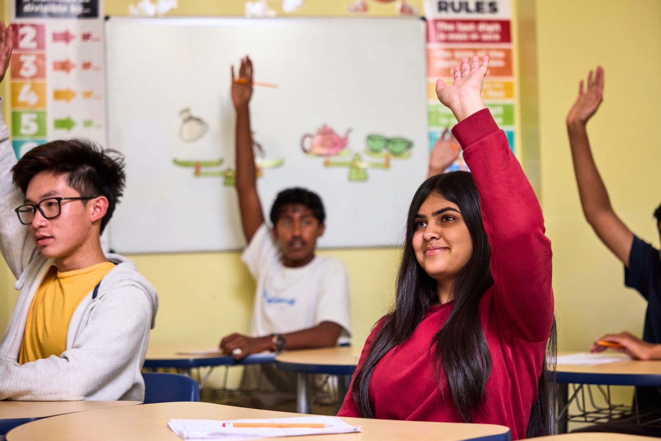 students raising hands