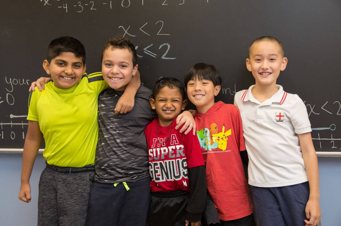 group of children near chalkboard
